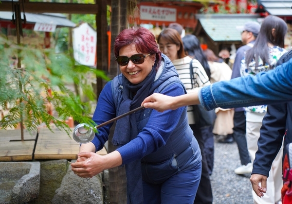 Customers wash hands before entering a temple