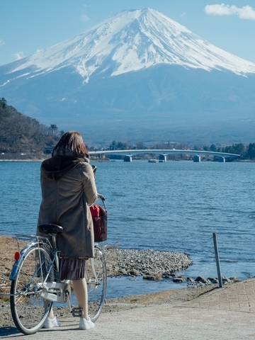 Capture Mount Fuji, its serene beauty reflecting in the surrounding lakes