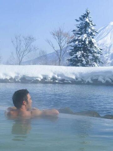 Soak in an onsen while enjoying the snow-covered scenery