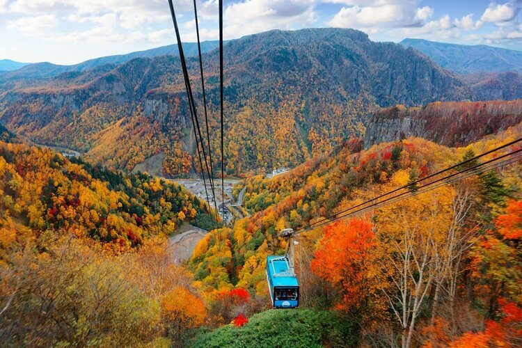 A cable car of Kurodake Ropeway flying in Sounkyo Gorge, Daisetsuzan National Park