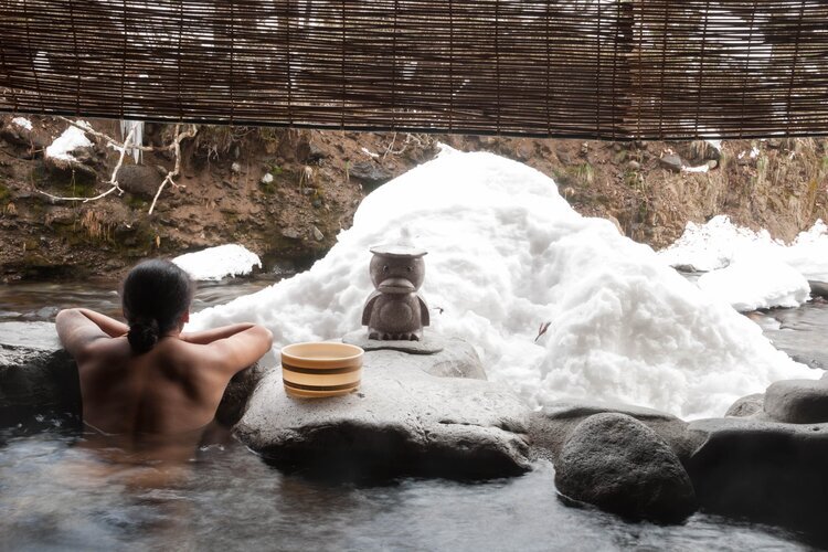 Soak in an onsen with snowy views