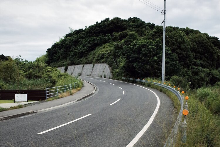 A curve road without any car at a rural area, Naoshima